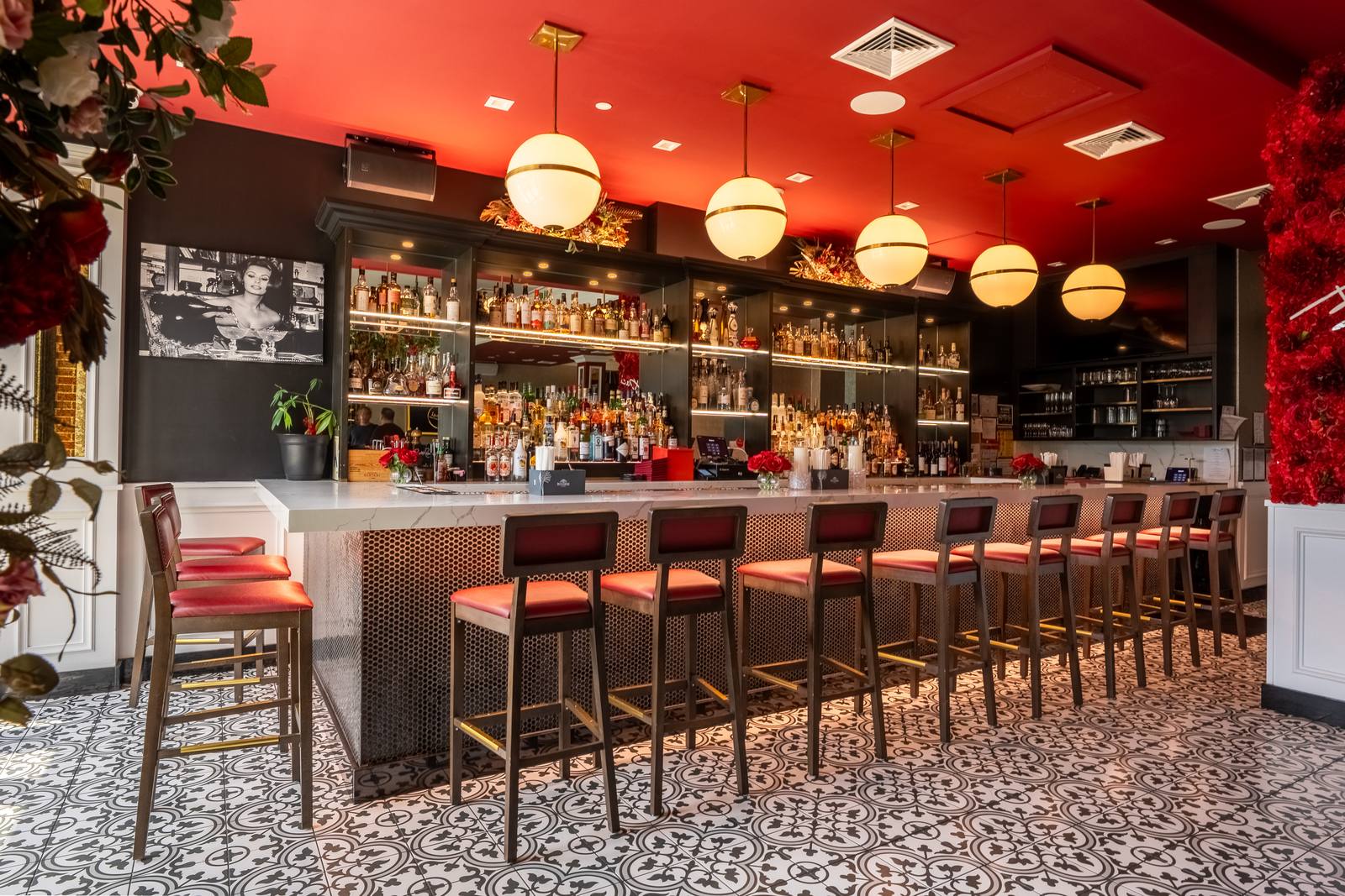 The bar at Baci with globe pendants and red leather stools